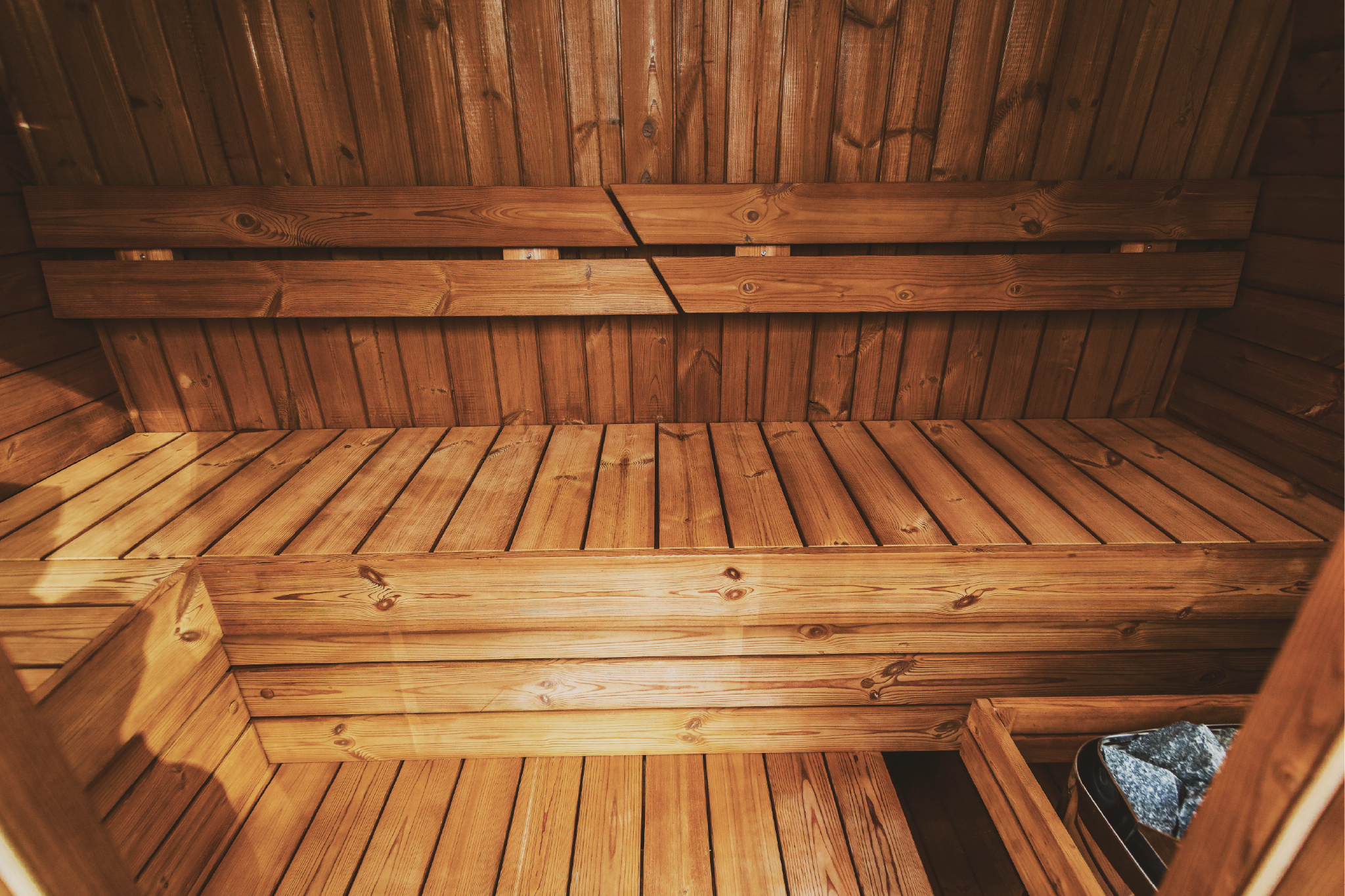 Interior of Mande Spa USA MW16 sauna made from sustainably sourced thermowood, featuring wooden benches and warm natural wood tones